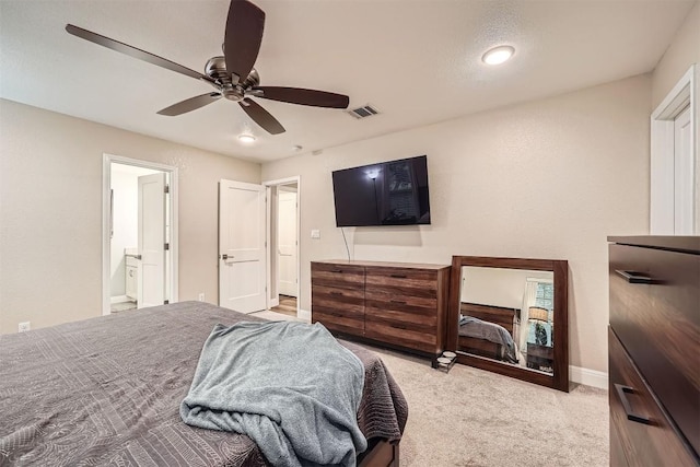100 Comanche Trl, Georgetown, TX 78633 - bedroom featuring light carpet, ceiling fan, baseboards, and ensuite bath