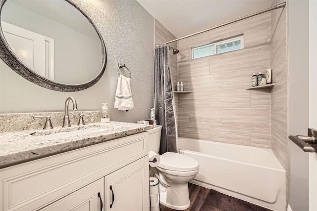 100 Comanche Trl, Georgetown, TX 78633 - full bath featuring vanity, shower / bath combination with curtain, wood finished floors, toilet, and a textured wall