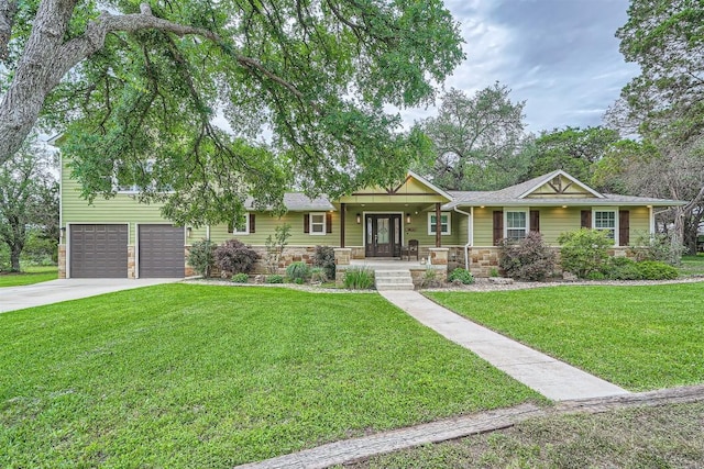 100 Comanche Trl, Georgetown, TX 78633 - ranch-style home with stone siding, covered porch, driveway, a garage, and a front yard
