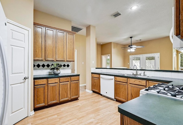 2713 Oakwood Glen Dr, Cedar Park, TX 78613 - kitchen with dishwasher, decorative backsplash, light wood-style flooring, and a ceiling fan