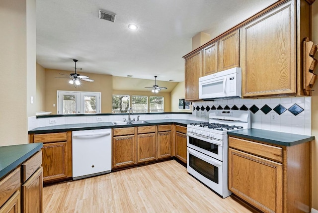 2713 Oakwood Glen Dr, Cedar Park, TX 78613 - kitchen featuring white appliances, a sink, ceiling fan, dark countertops, and recessed lighting