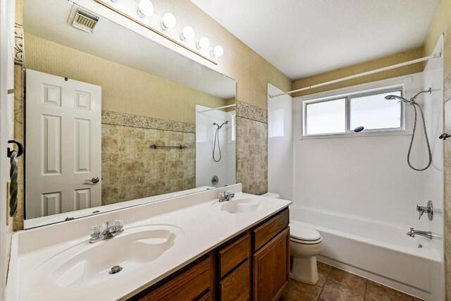 2713 Oakwood Glen Dr, Cedar Park, TX 78613 - bathroom featuring shower / bathtub combination, toilet, and double vanity