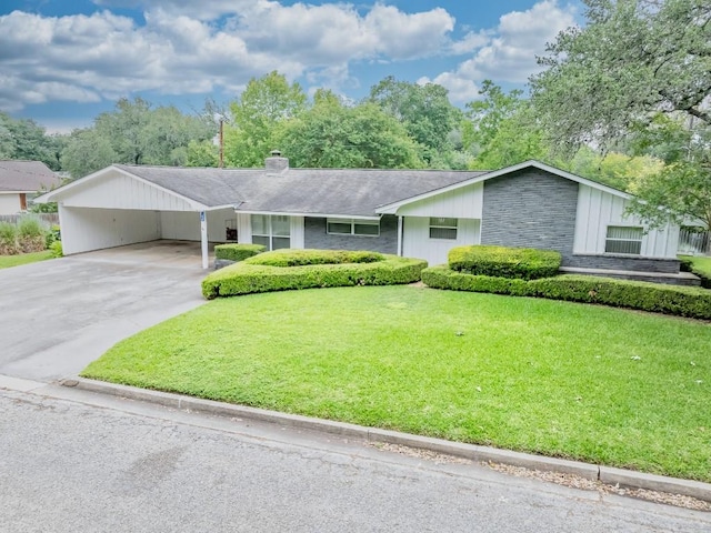 104 N Fair St, Gonzales, TX 78629 - view of front of property with a front lawn, driveway, a chimney, and a shingled roof