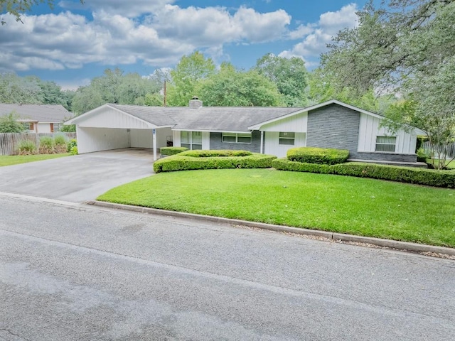 104 N Fair St, Gonzales, TX 78629 - view of front facade with driveway, a chimney, and an attached carport