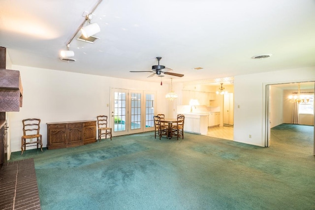 104 N Fair St, Gonzales, TX 78629 - sitting room with a chandelier, light colored carpet, ceiling fan, and french doors