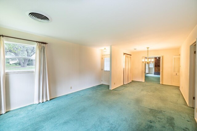 104 N Fair St, Gonzales, TX 78629 - carpeted empty room featuring a chandelier and baseboards