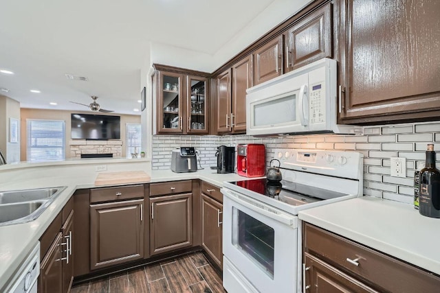 6900 E Riverside Dr Unit 6, Austin, TX 78741 - kitchen featuring white appliances, ceiling fan, backsplash, dark brown cabinetry, and recessed lighting