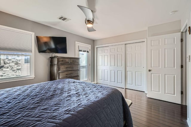 6900 E Riverside Dr Unit 6, Austin, TX 78741 - bedroom with wood finished floors, multiple windows, a closet, and ceiling fan