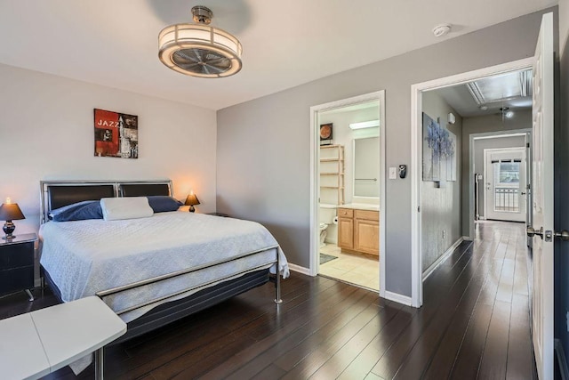 6900 E Riverside Dr Unit 6, Austin, TX 78741 - bedroom with attic access, baseboards, dark wood-type flooring, and ensuite bathroom