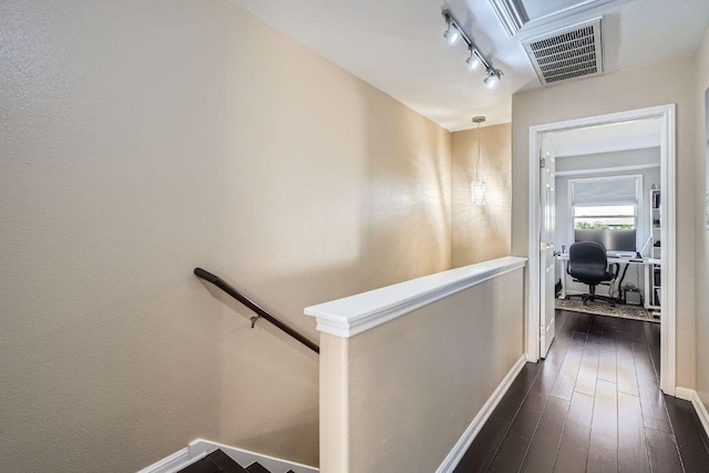 6900 E Riverside Dr Unit 6, Austin, TX 78741 - hallway featuring dark wood-style flooring, rail lighting, baseboards, and an office area