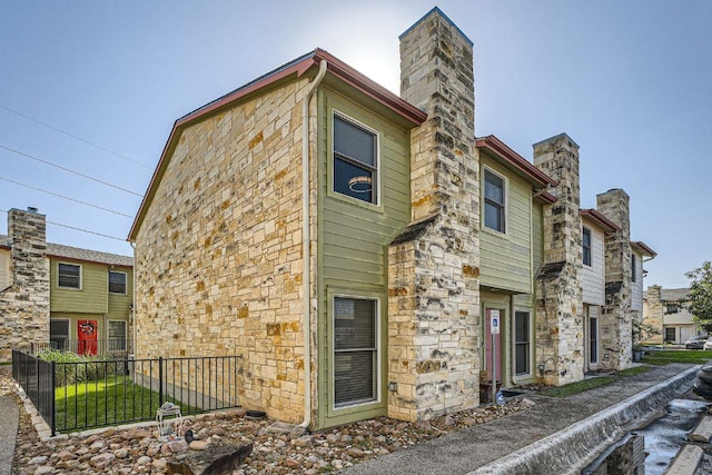 6900 E Riverside Dr Unit 6, Austin, TX 78741 - view of front of property with a chimney and stone siding