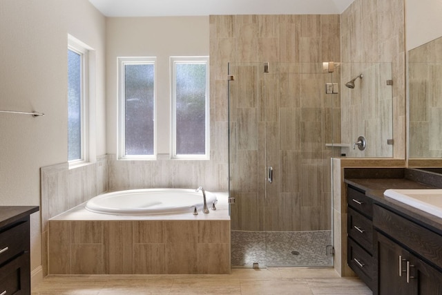 604 Germander Rd, Leander, TX 78641 - bathroom with vanity, a stall shower, a bath, and plenty of natural light