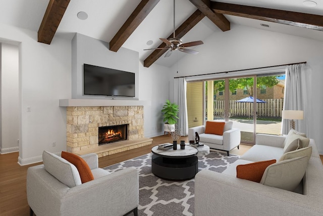 604 Germander Rd, Leander, TX 78641 - living area with wood finished floors, beam ceiling, baseboards, a fireplace, and high vaulted ceiling