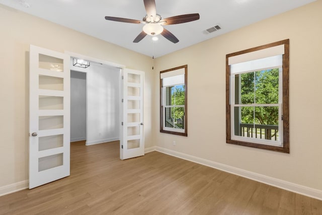 604 Germander Rd, Leander, TX 78641 - unfurnished bedroom featuring french doors, light wood-type flooring, baseboards, and a ceiling fan
