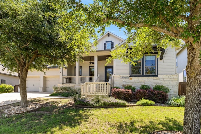 604 Germander Rd, Leander, TX 78641 - view of front of home with covered porch, ceiling fan, driveway, stone siding, and a front yard
