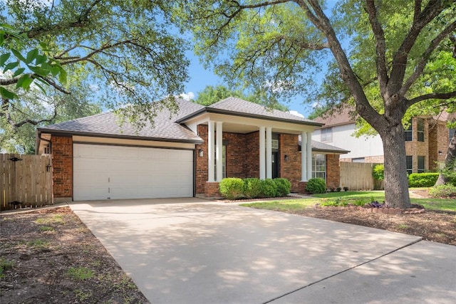 1202 Deergrove Dr, Cedar Park, TX 78613 - view of front of house with an attached garage, concrete driveway, brick siding, and roof with shingles