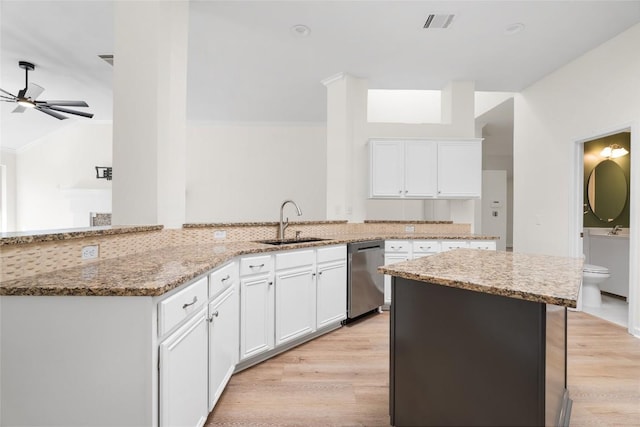 1202 Deergrove Dr, Cedar Park, TX 78613 - kitchen with stainless steel dishwasher, a sink, light stone counters, a ceiling fan, and lofted ceiling