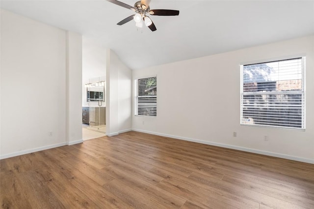 1202 Deergrove Dr, Cedar Park, TX 78613 - empty room with light wood finished floors, ceiling fan, baseboards, and lofted ceiling