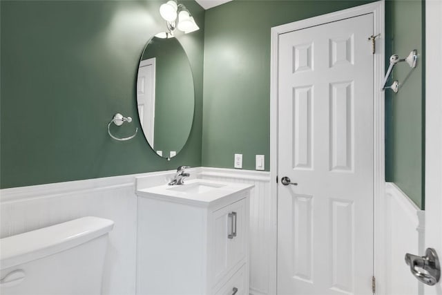 1202 Deergrove Dr, Cedar Park, TX 78613 - bathroom featuring wainscoting, toilet, vanity, and a decorative wall