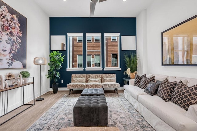 living room featuring wood finished floors, recessed lighting, and baseboards