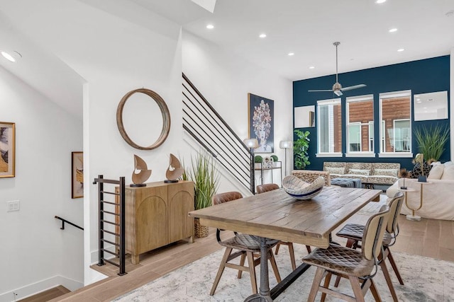 dining room with light wood finished floors, recessed lighting, a ceiling fan, and baseboards