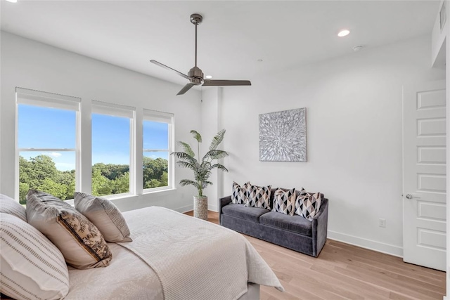 bedroom featuring baseboards, light wood-type flooring, recessed lighting, and ceiling fan