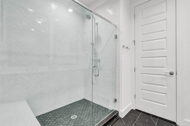 full bath with a stall shower and tile patterned floors