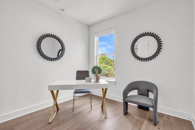 office space with wood finished floors and baseboards