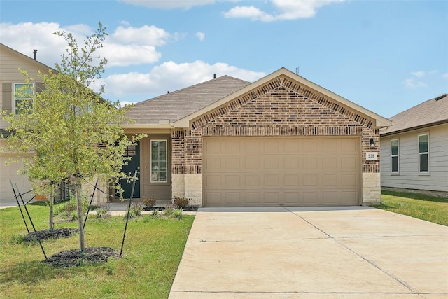 528 Evergreen Sumac Loop, Kyle, TX 78640 - ranch-style home featuring an attached garage, brick siding, driveway, a front yard, and a shingled roof