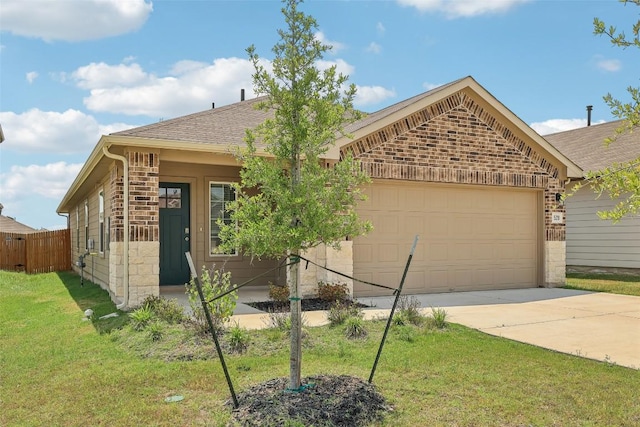 528 Evergreen Sumac Loop, Kyle, TX 78640 - view of front of house featuring a garage, concrete driveway, roof with shingles, and brick siding