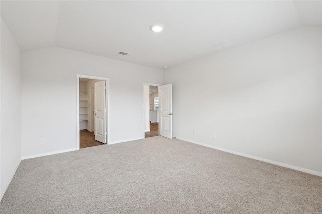 528 Evergreen Sumac Loop, Kyle, TX 78640 - unfurnished bedroom featuring lofted ceiling, carpet, baseboards, a spacious closet, and a closet