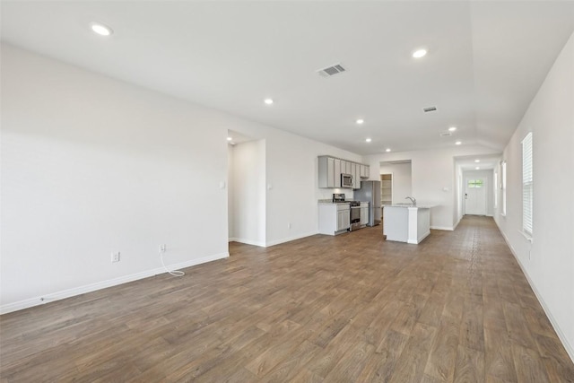 528 Evergreen Sumac Loop, Kyle, TX 78640 - unfurnished living room featuring recessed lighting, wood finished floors, and baseboards
