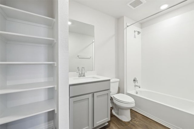 528 Evergreen Sumac Loop, Kyle, TX 78640 - full bath with wood finished floors, toilet, vanity, washtub / shower combination, and recessed lighting