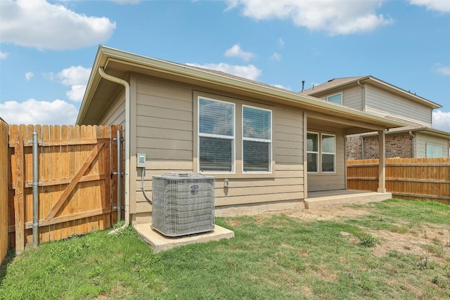 528 Evergreen Sumac Loop, Kyle, TX 78640 - back of house featuring central AC unit and a gate