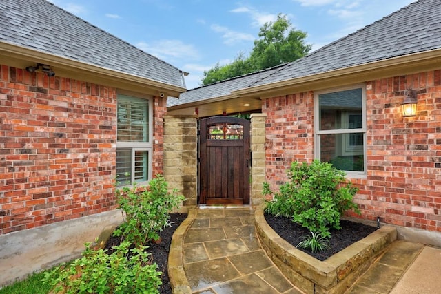 18004 Rosebud Pl, Round Rock, TX 78681 - property entrance featuring a shingled roof, a gate, and brick siding