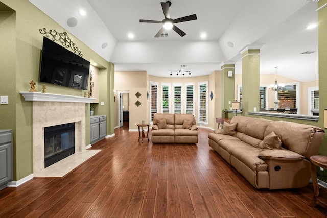 18004 Rosebud Pl, Round Rock, TX 78681 - living area featuring a fireplace, dark wood-style floors, a ceiling fan, a chandelier, and vaulted ceiling