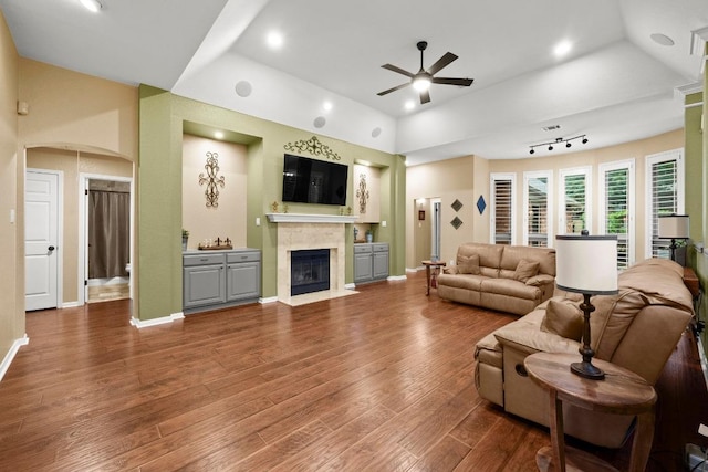 18004 Rosebud Pl, Round Rock, TX 78681 - living room with ceiling fan, arched walkways, a premium fireplace, wood finished floors, and recessed lighting