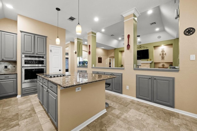 18004 Rosebud Pl, Round Rock, TX 78681 - kitchen featuring gray cabinets, ornate columns, a center island, double oven, and black electric stovetop