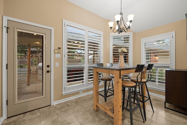 18004 Rosebud Pl, Round Rock, TX 78681 - dining space with a chandelier, baseboards, and vaulted ceiling