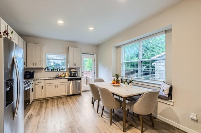 17301 Leafroller Dr Unit A, Pflugerville, TX 78660 - kitchen with stainless steel appliances, a sink, healthy amount of natural light, light wood finished floors, and recessed lighting