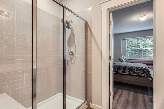 17301 Leafroller Dr Unit A, Pflugerville, TX 78660 - bathroom featuring connected bathroom, a shower stall, and wood finished floors