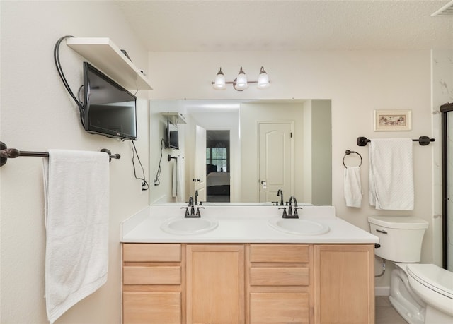 1810 Summer Rain Dr, Cedar Park, TX 78613 - ensuite bathroom with double vanity, toilet, and a textured ceiling