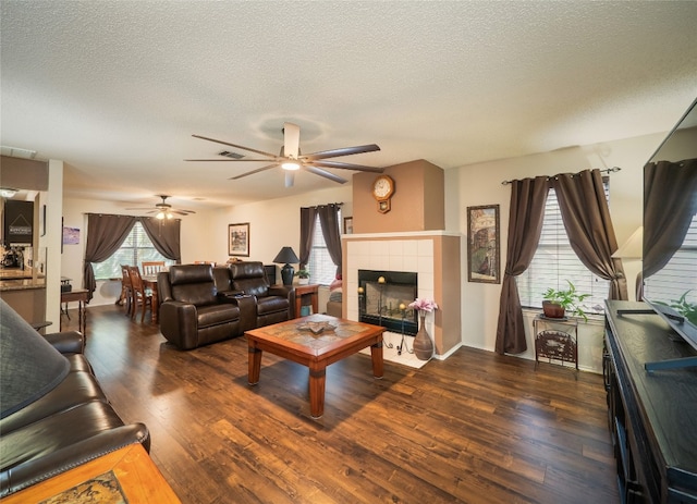 1810 Summer Rain Dr, Cedar Park, TX 78613 - living area featuring a textured ceiling, ceiling fan, wood finished floors, and a tile fireplace