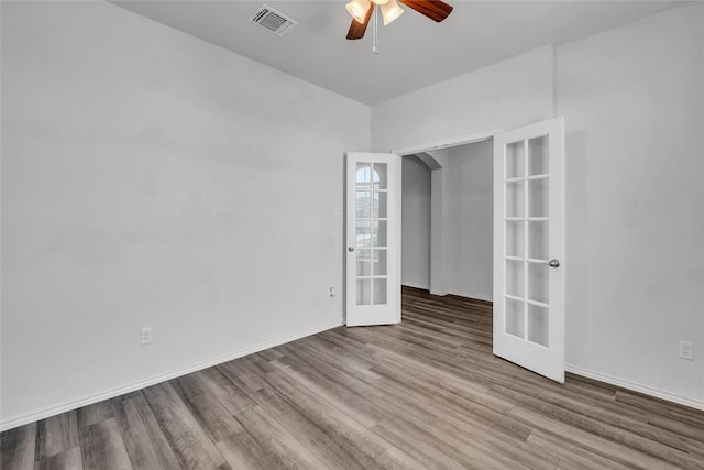 208 Nathaniel Dr, Taylor, TX 76574 - empty room with french doors, a ceiling fan, and wood finished floors
