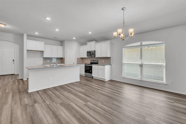 kitchen with stainless steel appliances, light wood-type flooring, recessed lighting, white cabinets, and baseboards