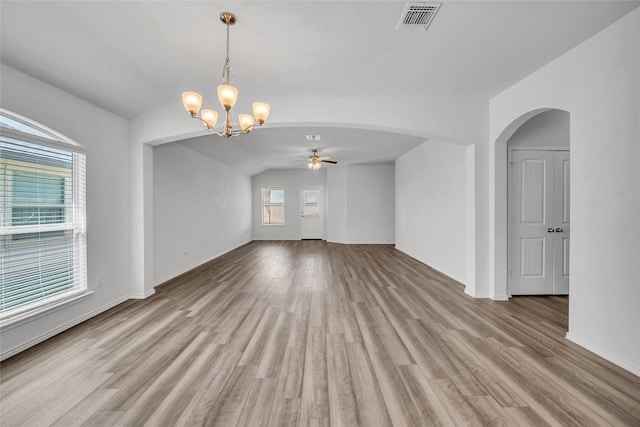 208 Nathaniel Dr, Taylor, TX 76574 - unfurnished room with a ceiling fan, a chandelier, light wood-style floors, and arched walkways
