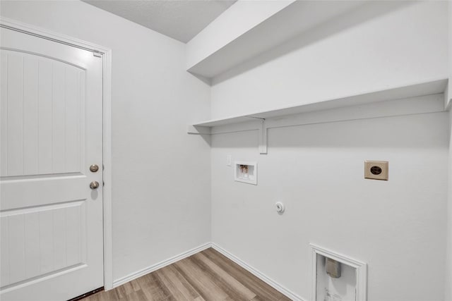 laundry room featuring washer hookup, gas dryer hookup, hookup for an electric dryer, wood finished floors, and baseboards