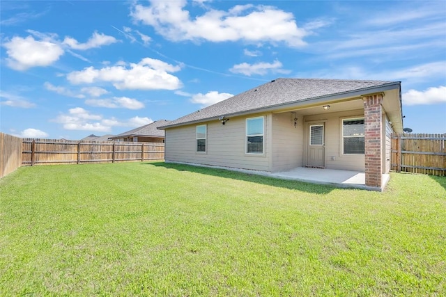 rear view of property with a patio area and a shingled roof