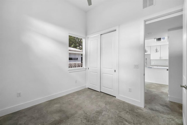 1314 Delano St Unit A, Austin, TX 78721 - unfurnished bedroom with concrete flooring, a closet, baseboards, and a ceiling fan