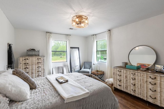 326 Zapalac Rd, Smithville, TX 78957 - bedroom with multiple windows and dark wood-style flooring